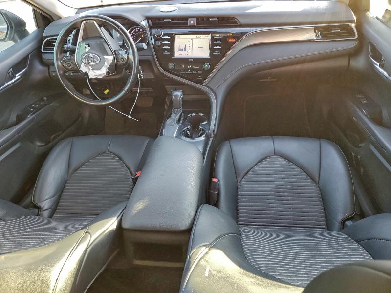 2020 Toyota Camry SE interior showing clean black leather seats and dashboard - looks fine at first glance